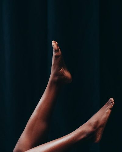 Silhouette of a person in a balance pose against a dark background.